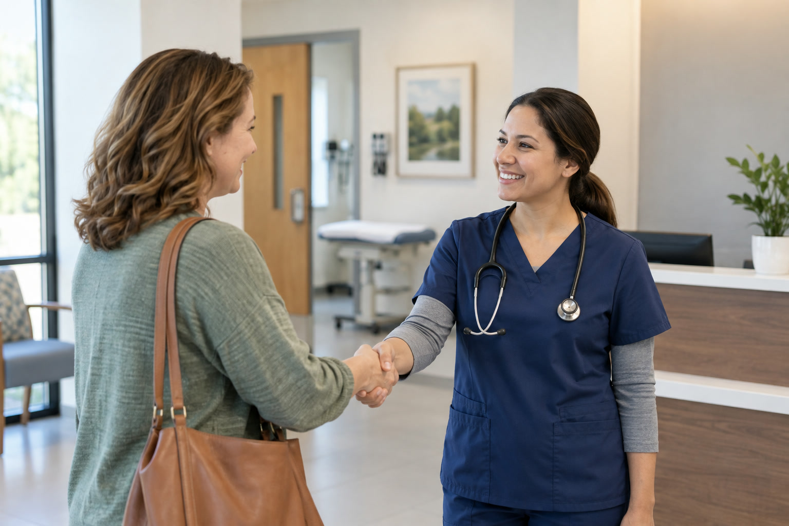 A clinician greeting an adult visitor at an urgent-care reception area